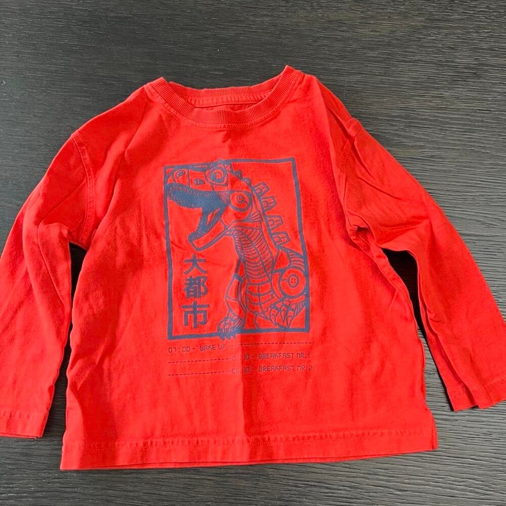 John Lewis red long sleeve kids top with blue dinosaur graphic and Chinese chara